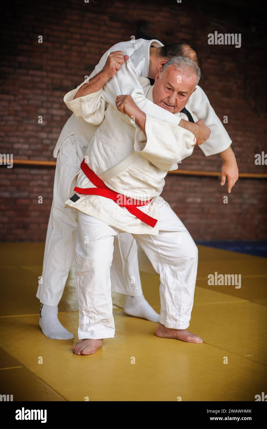 Judo sensei master instructor in traditional gi kimono demonstrate judo