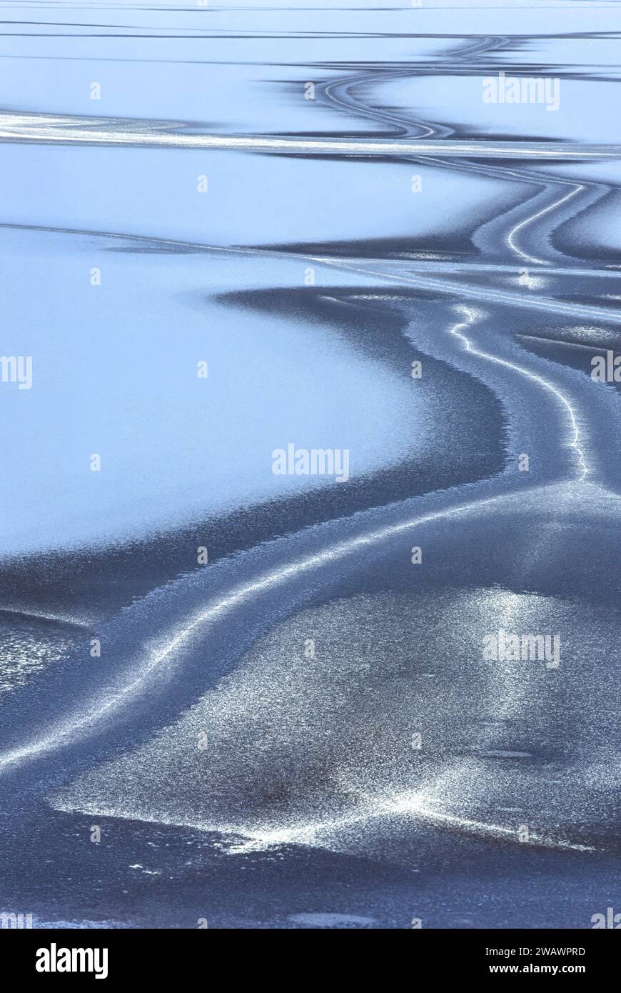 Winter and patterns in the ice of a frozen Loch or Lake in Scotland Stock Photo
