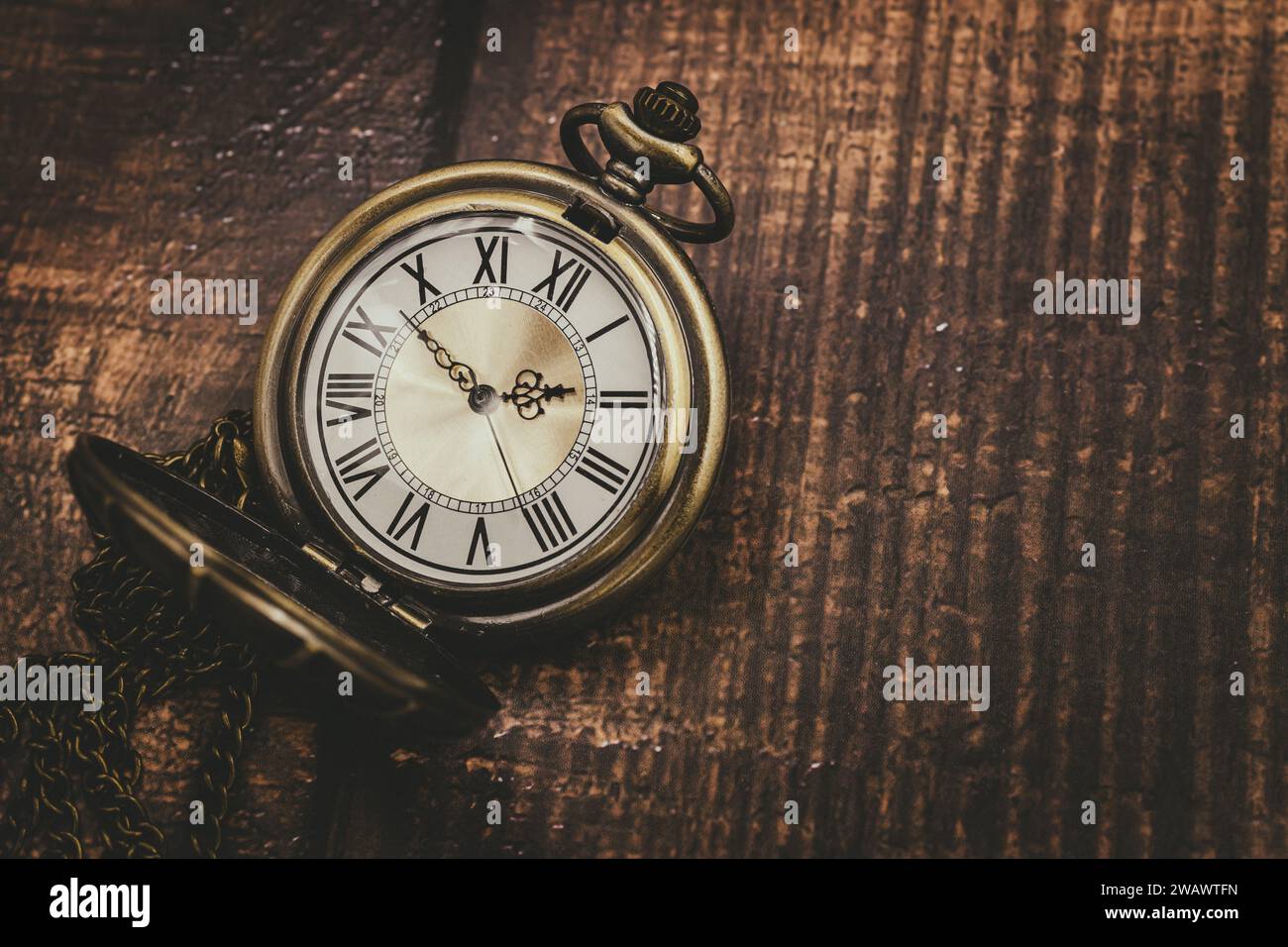 old pocket watch classic clock time vintage retro style on wood background with space for text Stock Photo