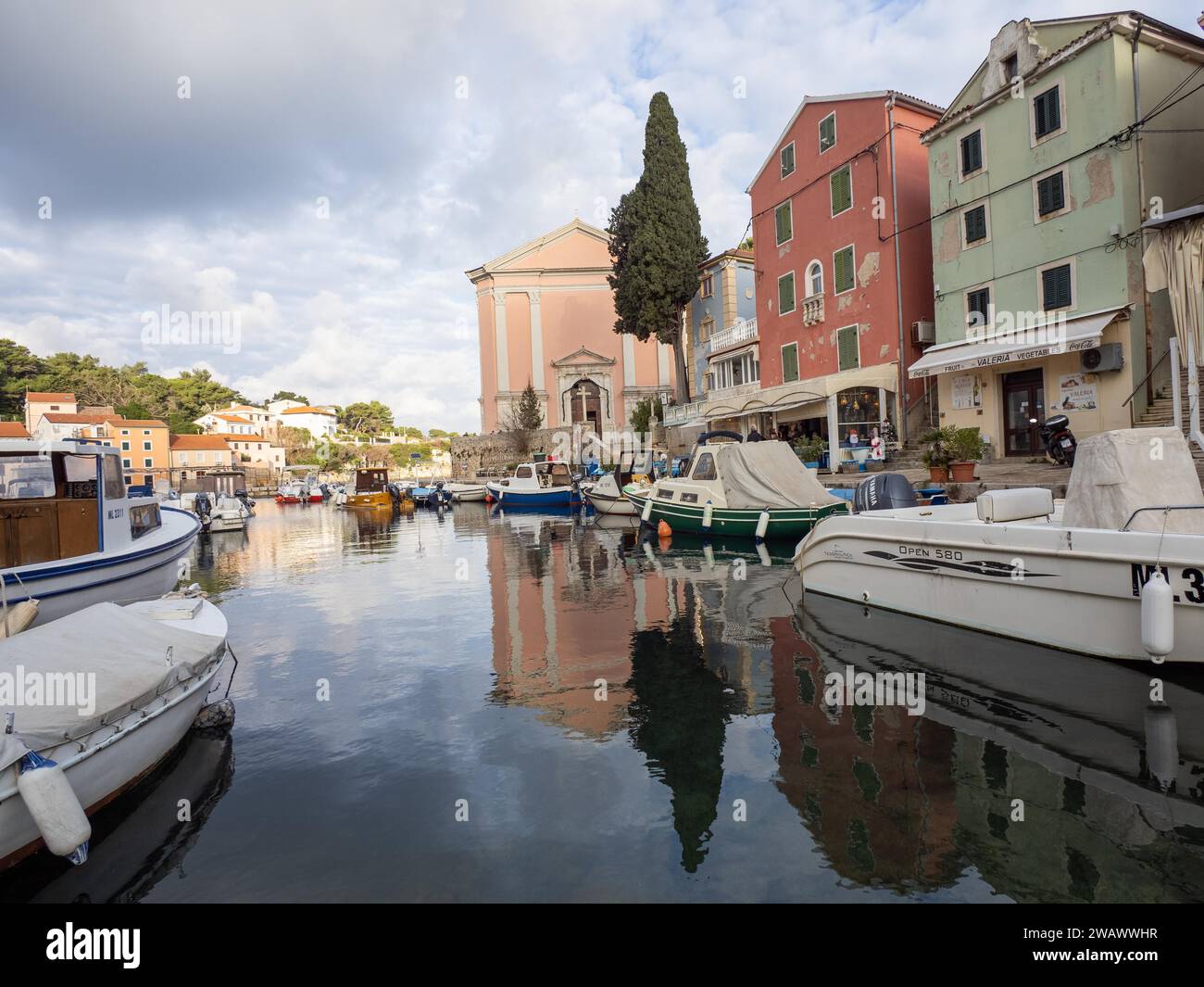 St. Anthony's Church in the morning light, boats in the harbour, Veli ...