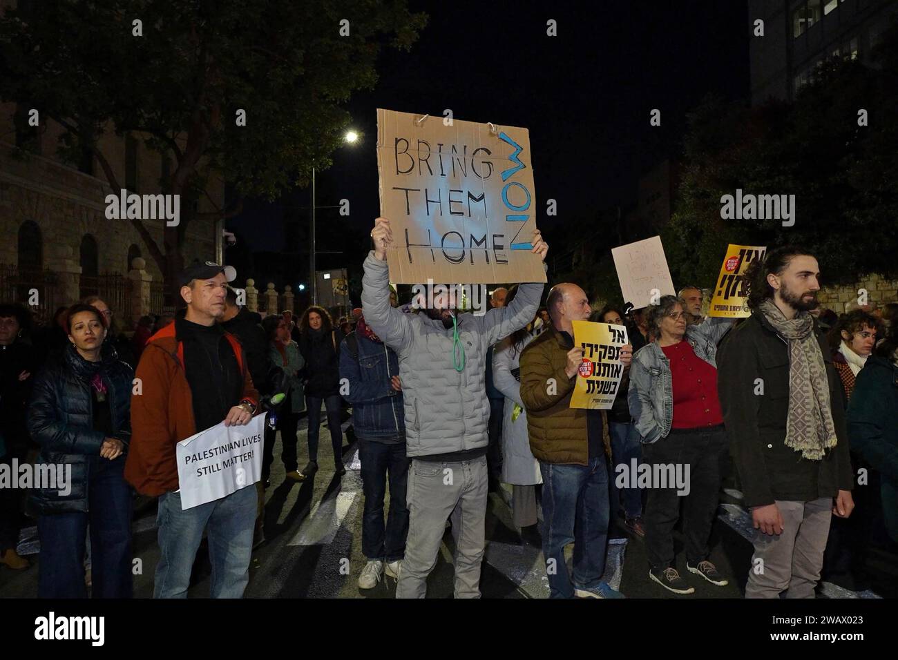 Israelis hold signs and chant, 'Bring everybody home,' during a rally calling for a deal to free Israeli hostages held in the Gaza Strip on January 6, 2024 in Jerusalem. More than 100 Israeli hostages captured on Oct. 7 remain held in Gaza by Hamas and other militant groups, according to Israeli authorities. Stock Photo