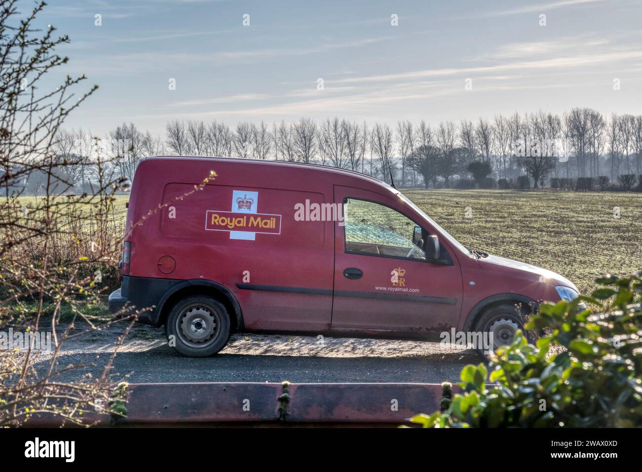 A Royal Mail post van parked in a country lane in Norfolk. Stock Photo