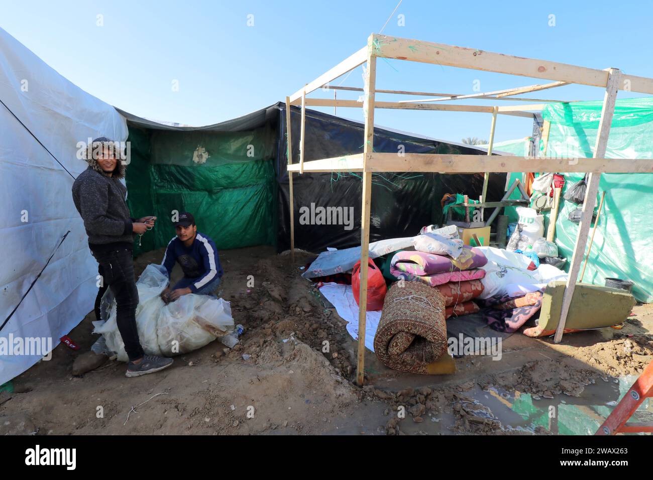 Palestinian families remove their tents from a shelter center in Al ...