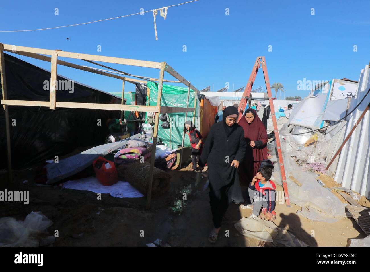 Palestinian families remove their tents from a shelter center in Al ...