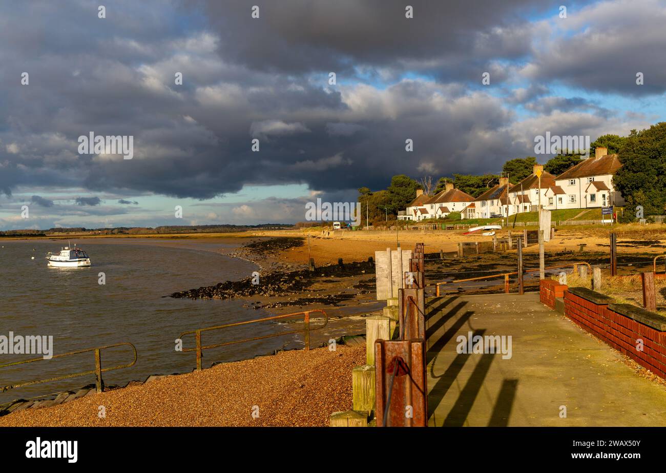 Storm clouds over beach and buildings at Bawdsey Quay, Suffolk, England, UK Stock Photo