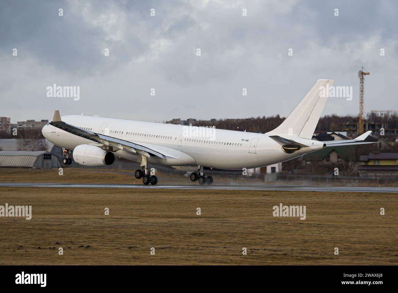 SmartLynx Malta Airbus A330-343 touching down on the runway at Lviv Airport Stock Photo