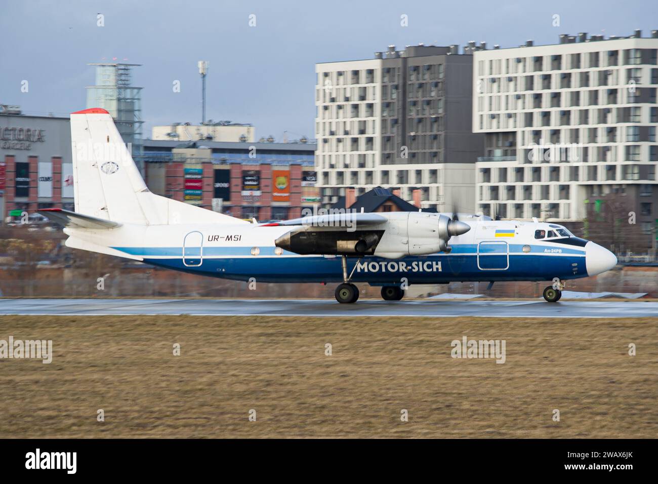 Ukrainian airline's Motor Sich Antonov An-24RV regional aircraft taxiing on the runway for takeoff from Lviv Airport Stock Photo