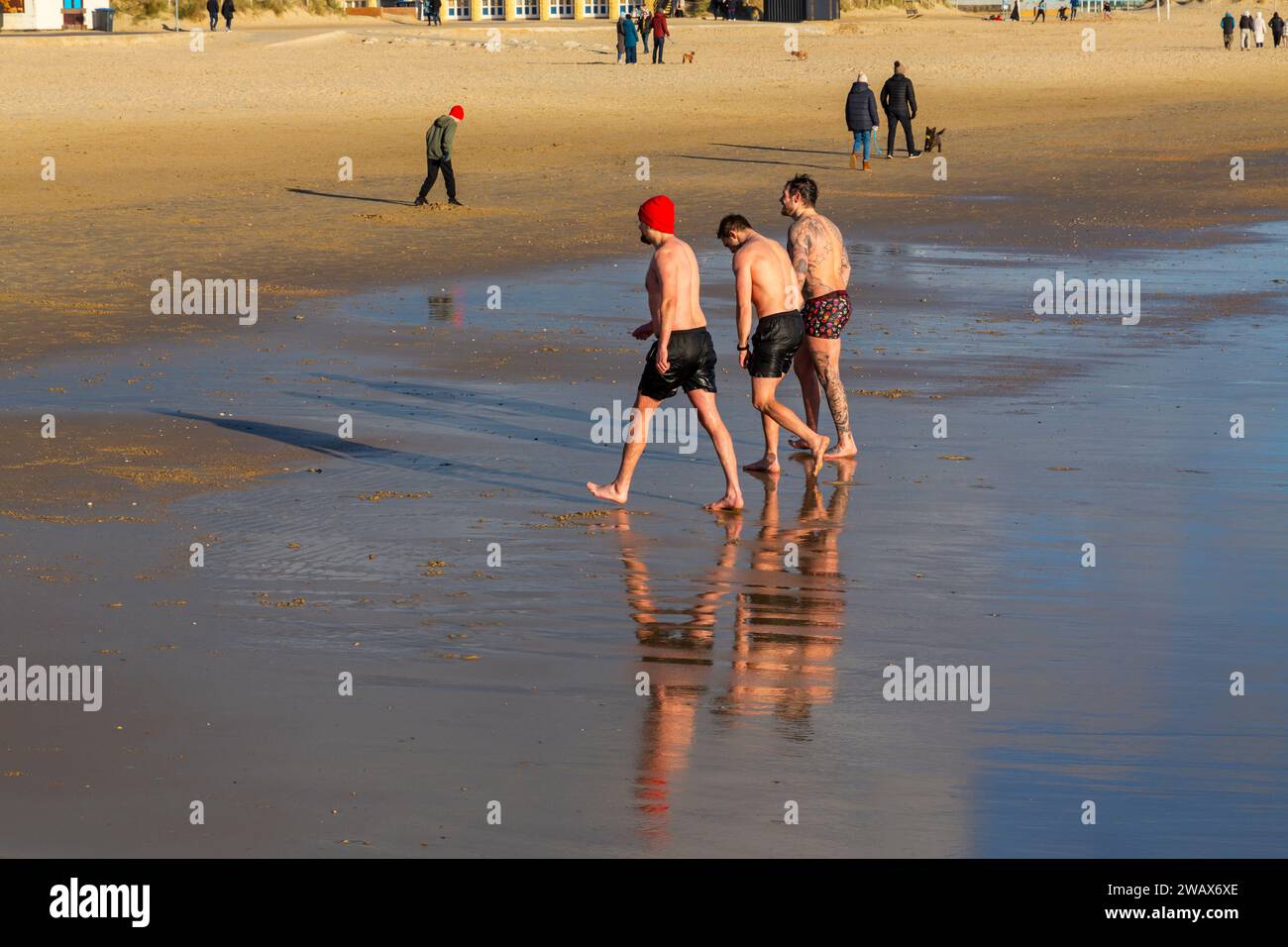 Sandbanks, Poole, Dorset UK. 7th January 2024. UK weather: a cold sunny morning at Sandbanks beach as many people take some exercise and go for a stroll along the seashore with some brave souls even going into the sea Credit: Carolyn Jenkins/Alamy Live News Stock Photo