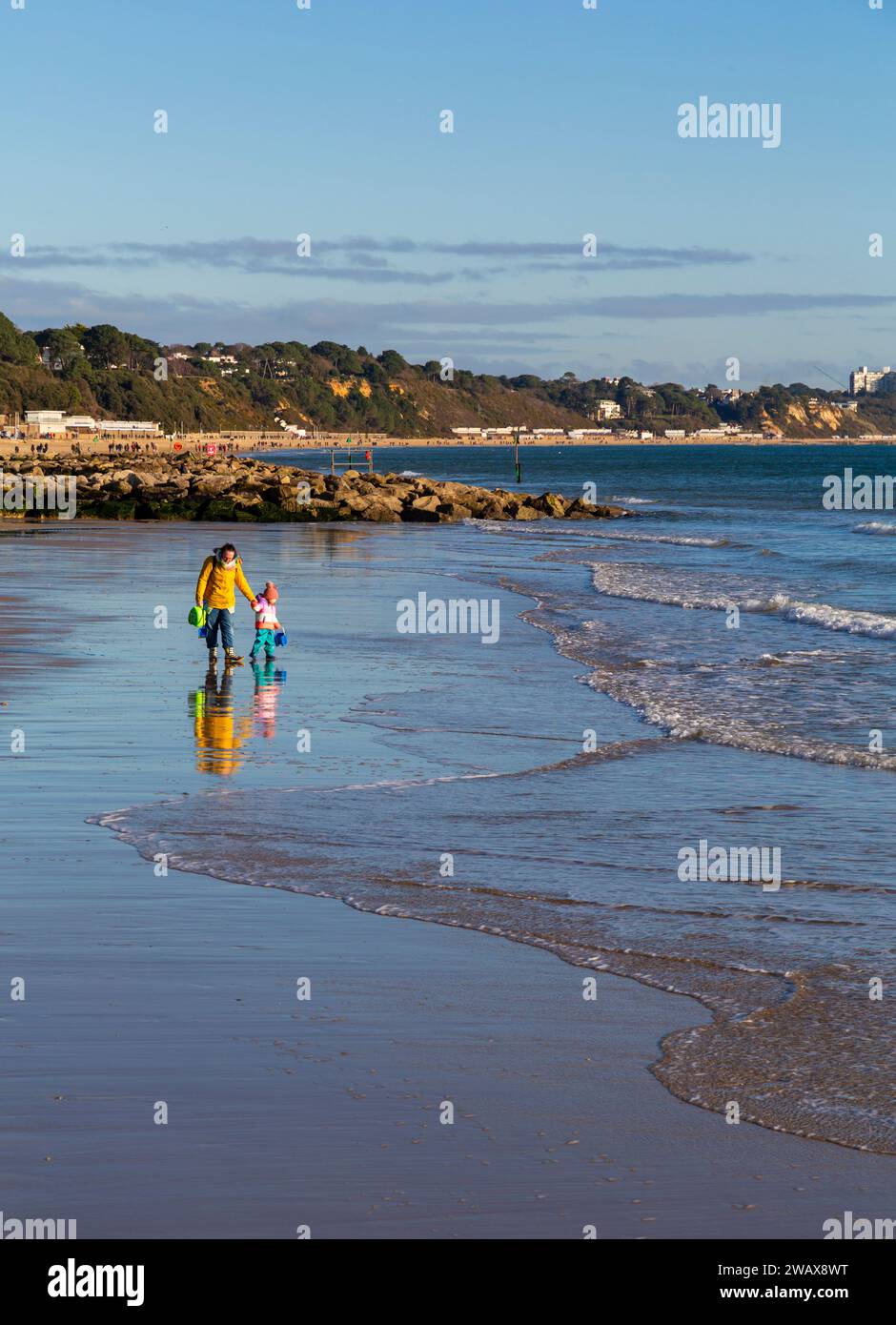 Sandbanks, Poole, Dorset UK. 7th January 2024. UK weather: a cold sunny morning at Sandbanks beach as many people take some exercise and go for a stroll along the seashore with some brave souls even going into the sea Credit: Carolyn Jenkins/Alamy Live News Stock Photo