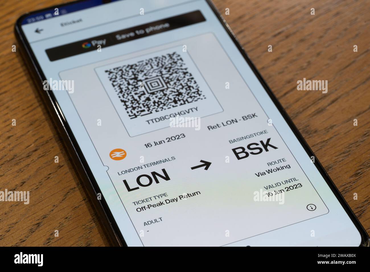 An e ticket with a QR code for train travel from London to Basingstoke, purchased with the Trainline App, on a smartphone screen. Theme: train travel Stock Photo