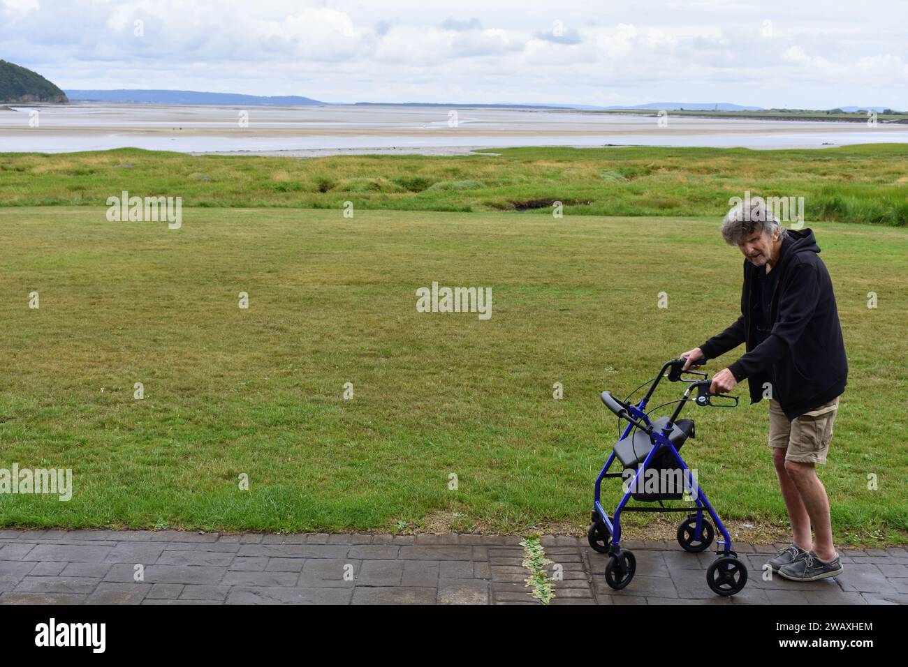 Man with mobility walker, Laugharne, Carmarthenshire, Wales Stock Photo
