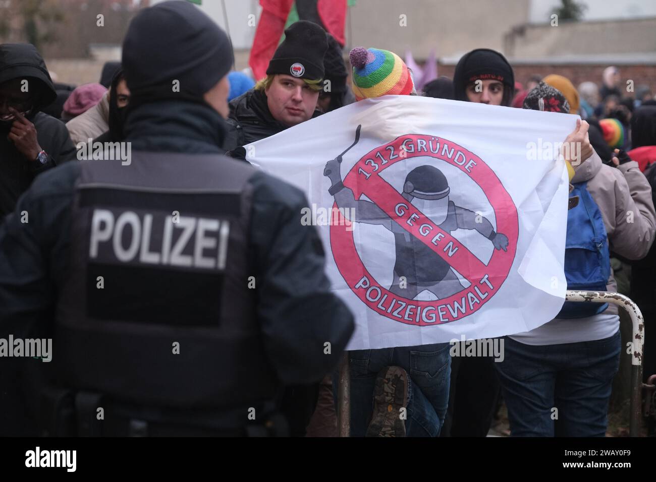 07 January 2024, Saxony-Anhalt, Dessau-Roßlau: Participants in a left-wing demonstration stand together with banners and flags. The occasion is the 19th anniversary of the death of asylum seeker Oury Jalloh, who died in a police cell on January 7, 2005. Photo: Sebastian Willnow/dpa Stock Photo
