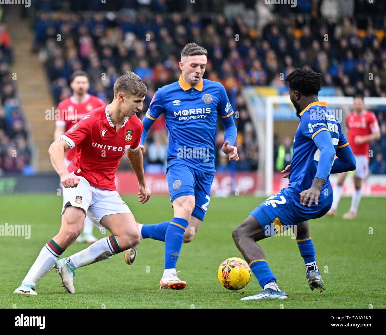 Shrewsbury, UK. 07th Jan, 2024. Max Cleworth of Wrexham gets tackled by