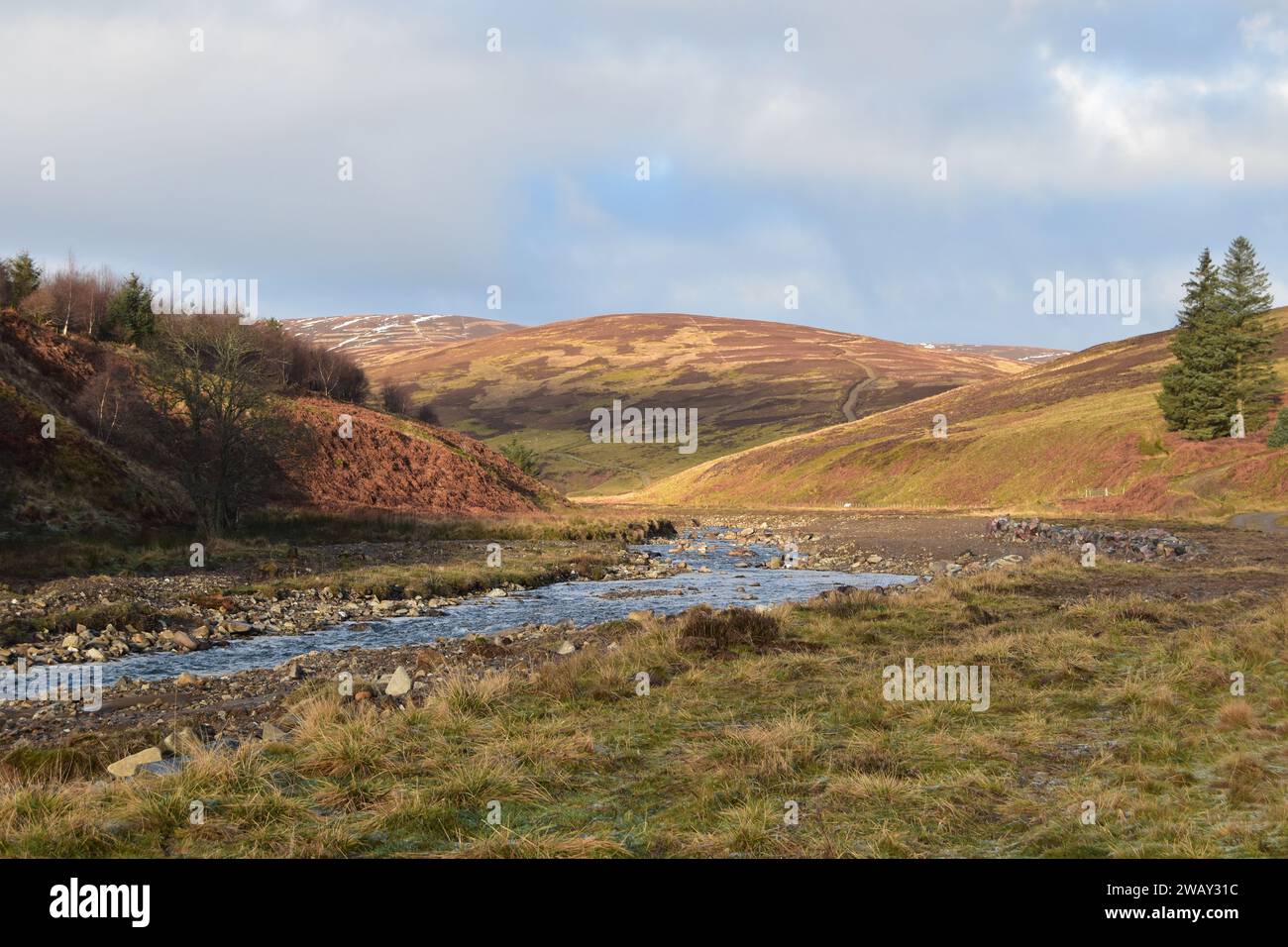 Noran Water winds through Glenogil in the Angus Glens on a dry January day in Scotland. Stock Photo