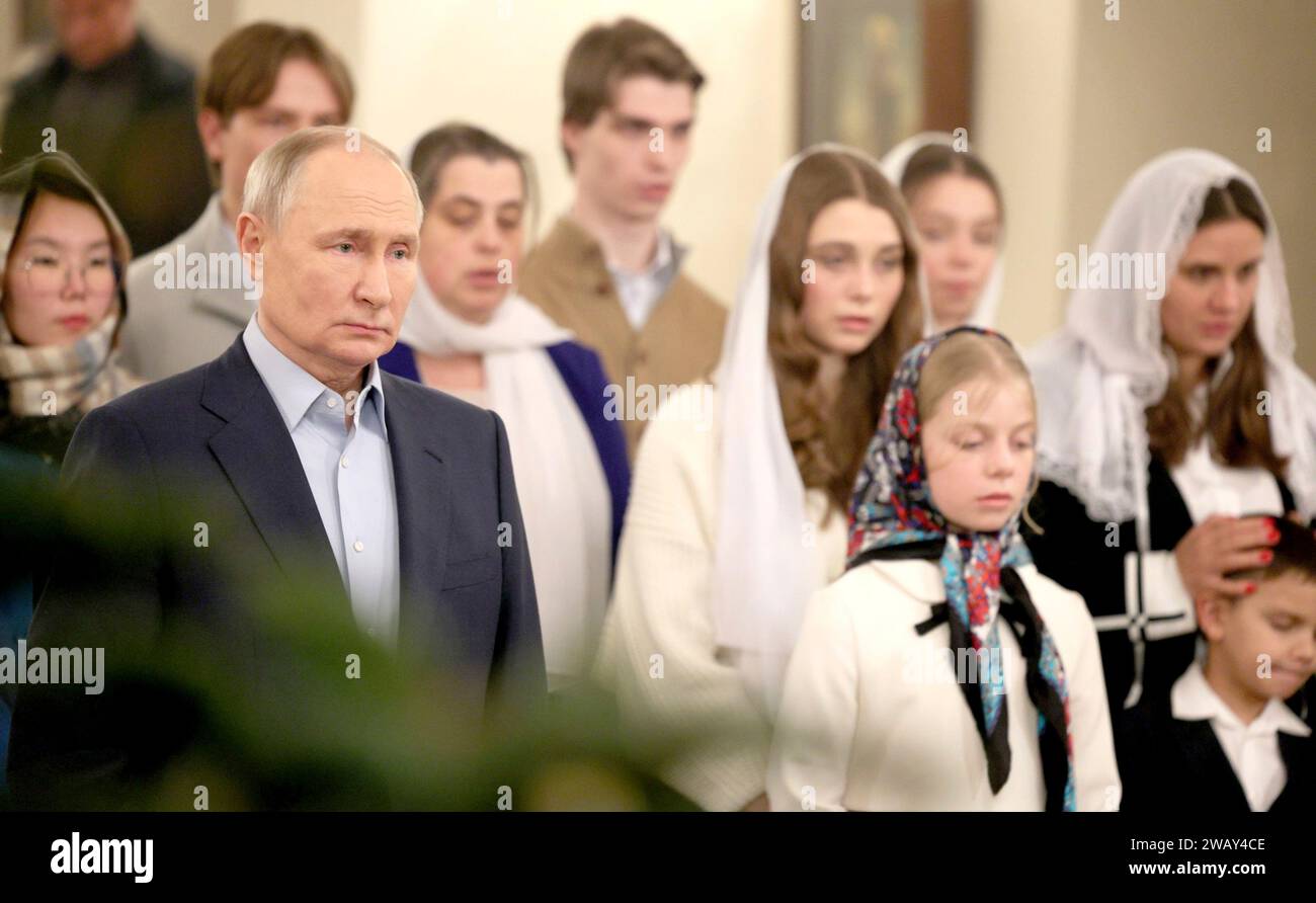 Novo-Ogaryovo, Russia. 07th Jan, 2024. Russian President Vladimir Putin attends an Orthodox Christmas service at the Church of the Icon of Savior Not Made by Hands at the official presidential residence of Novo-Ogaryovo, January 7, 2024 in Novo-Ogaryovo, Moscow Oblast, Russia. Putin hosted families of soldiers killed in the Ukraine war for the celebration. Credit: Gavriil Grigorov/Kremlin Pool/Alamy Live News Stock Photo