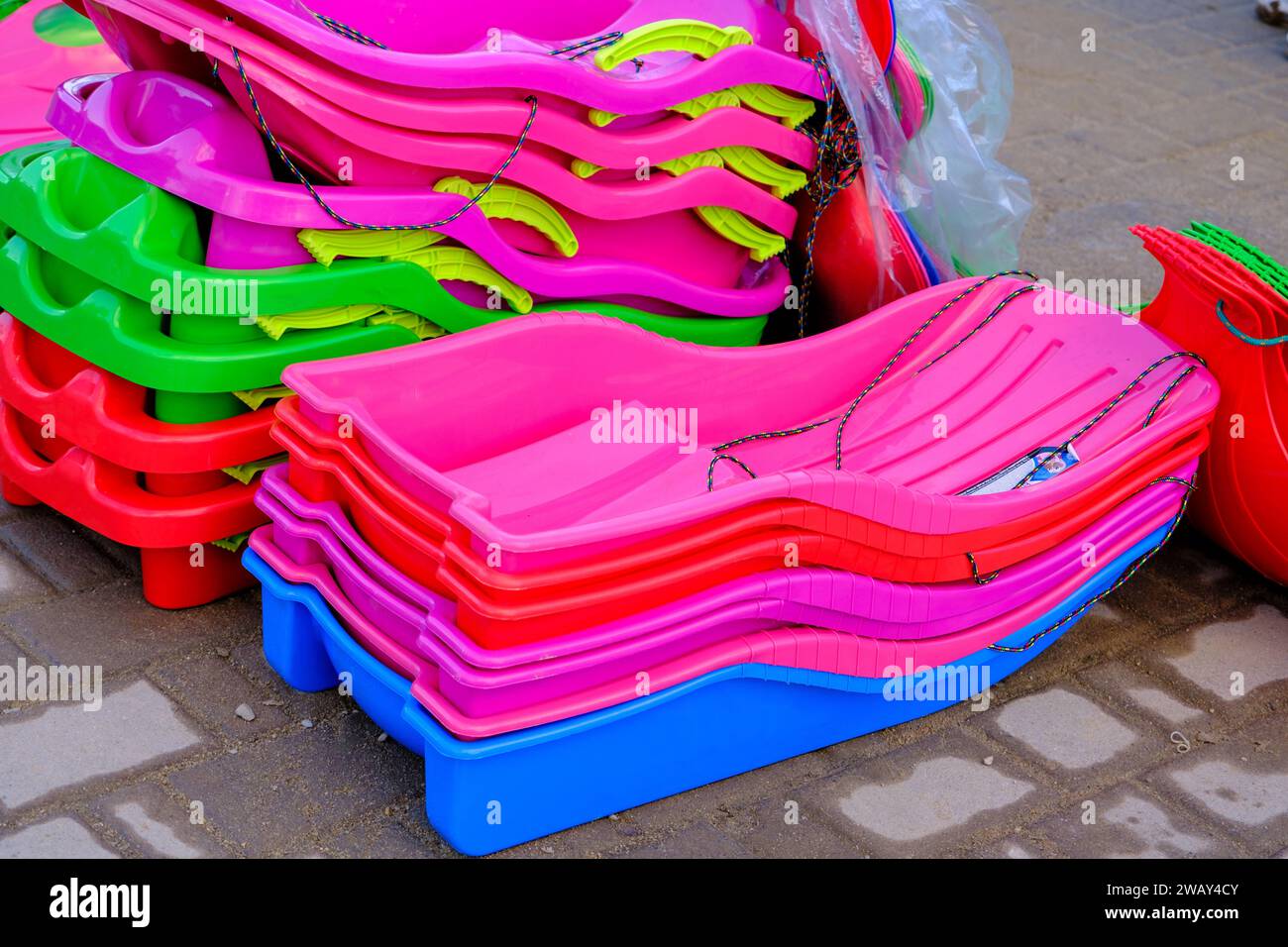 Background of the colorful sides of plastic sleds Stock Photo