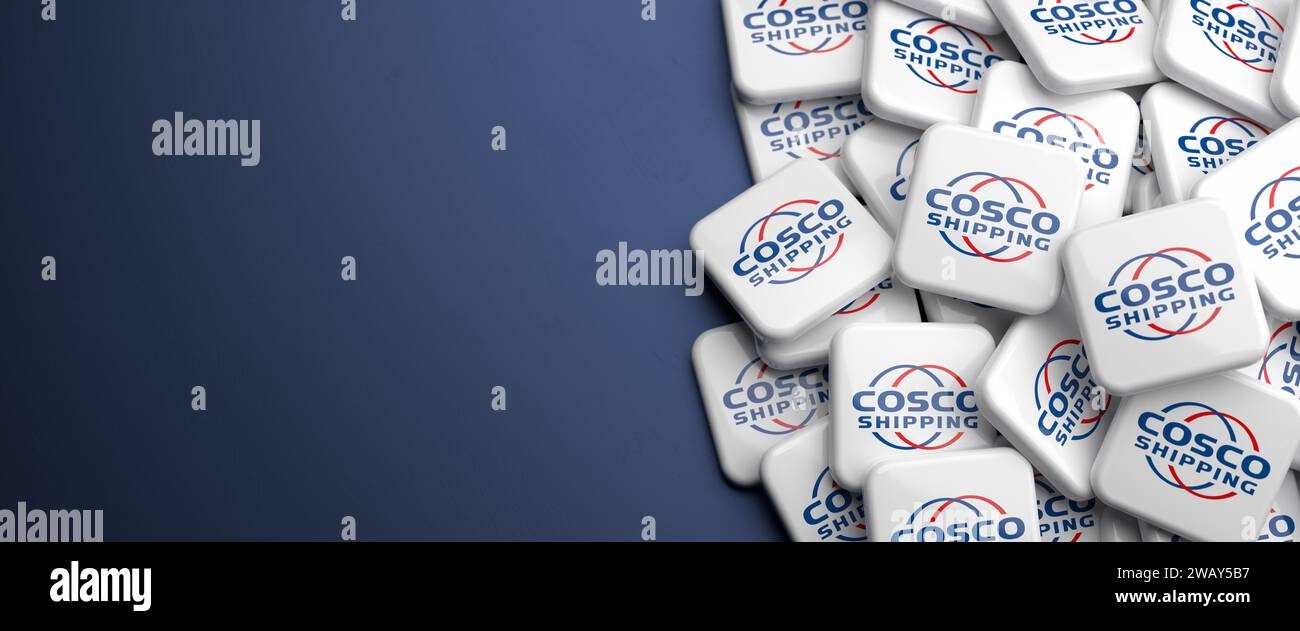 Logo of one of the five largest container shipping companies on a heap on a table: Cosco Stock Photo