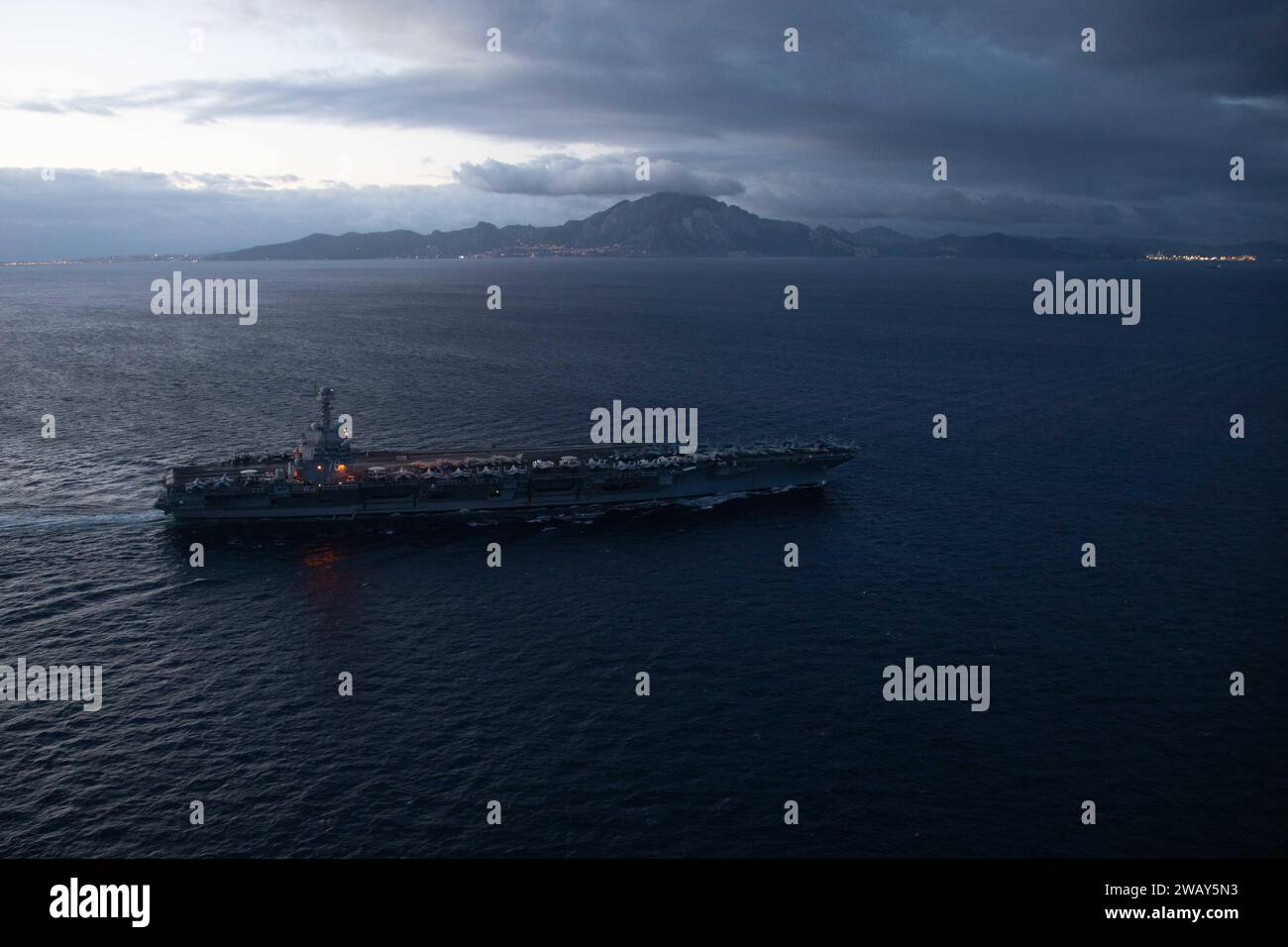 Mediterranean Sea, Spain. 05th Jan, 1617. The U.S. Navy Ford-class aircraft carrier USS Gerald R. Ford transits the Strait of Gibraltar on a stormy evening as it departs the Mediterranean Sea, January 5, 2024 off the coast of Spain. Credit: MC2 Jacob Mattingly/U.S. Navy Photo/Alamy Live News Stock Photo