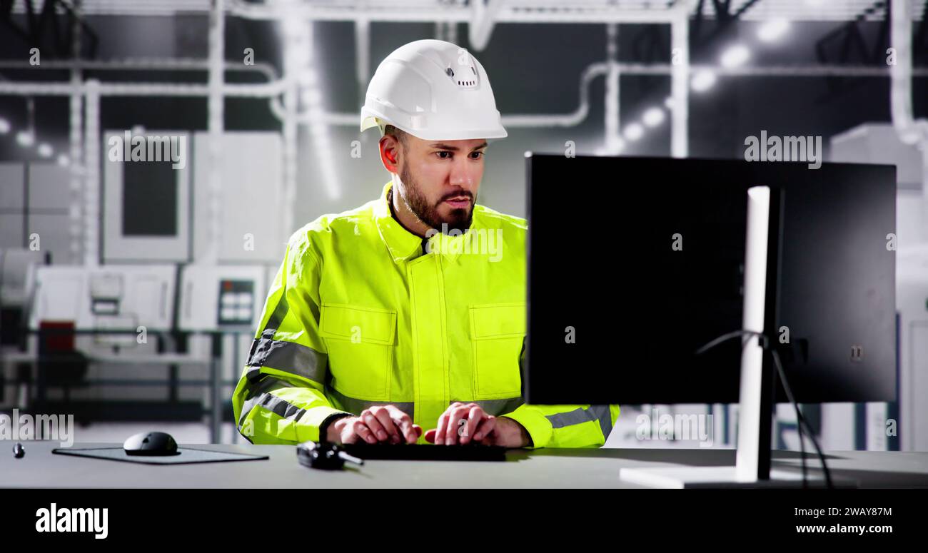 Engineer Using PC In Automated Semiconductor Assembly Line Stock Photo