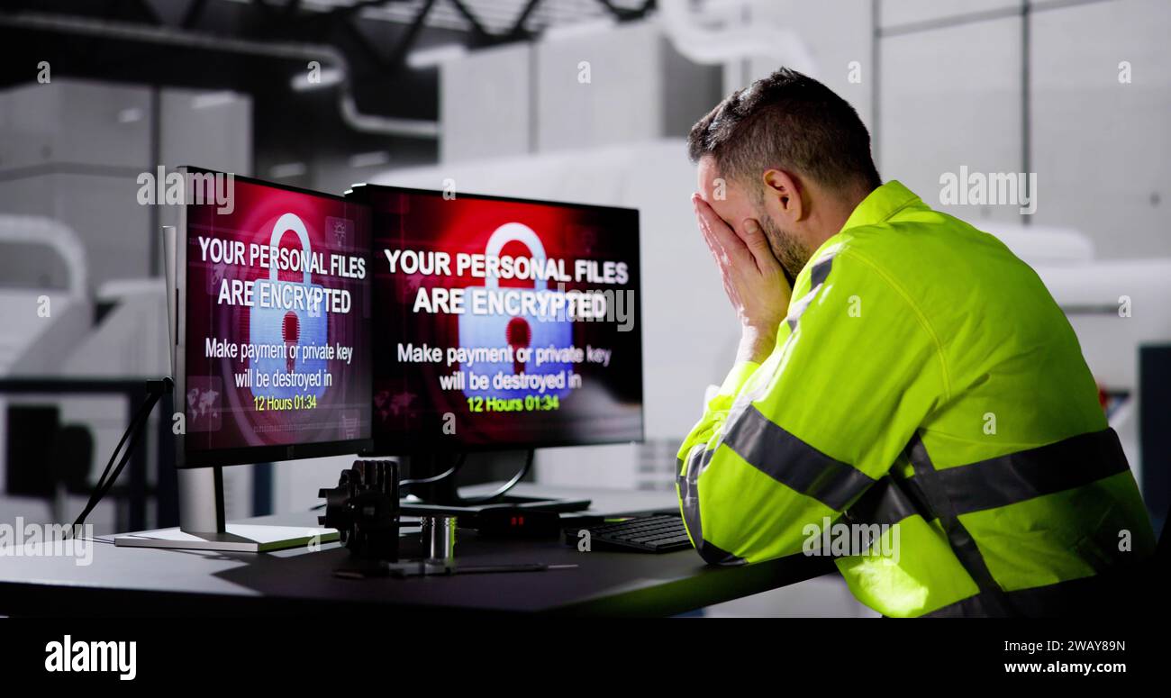 Shocked Engineer In Automated Semiconductor Factory During Ransomware Attack Stock Photo