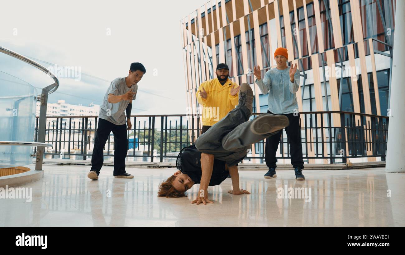 Hip hop team dance break dance while multicultural friend surrounded ...