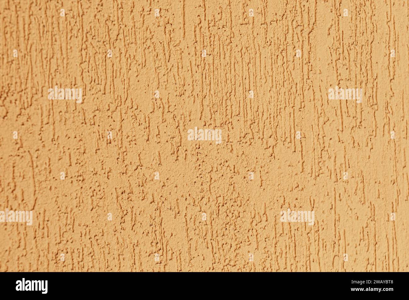 Yellow sand color decorative plaster wall texture. Horizontal photo. Stock Photo