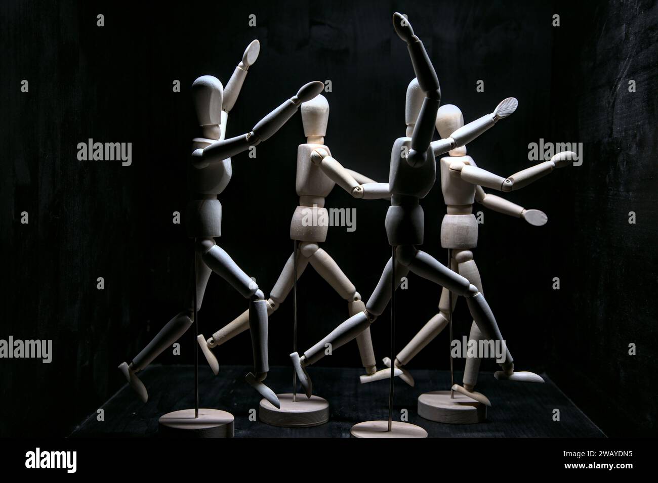 Wooden figurines acting like they are running away from something Stock