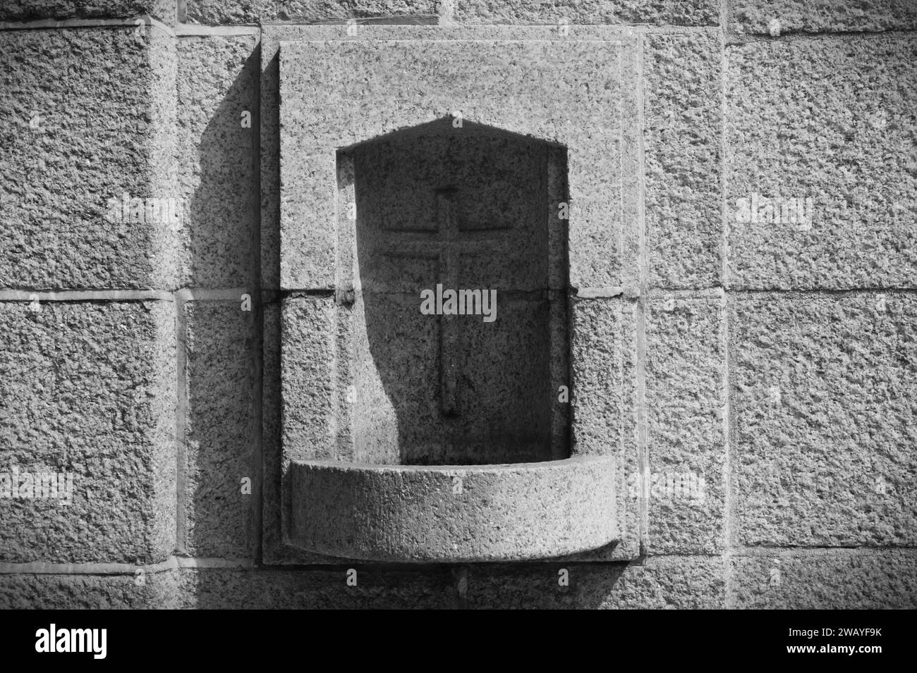 A stoup is a vessel containing holy water placed near the entrance of a Catholic church. Stock Photo