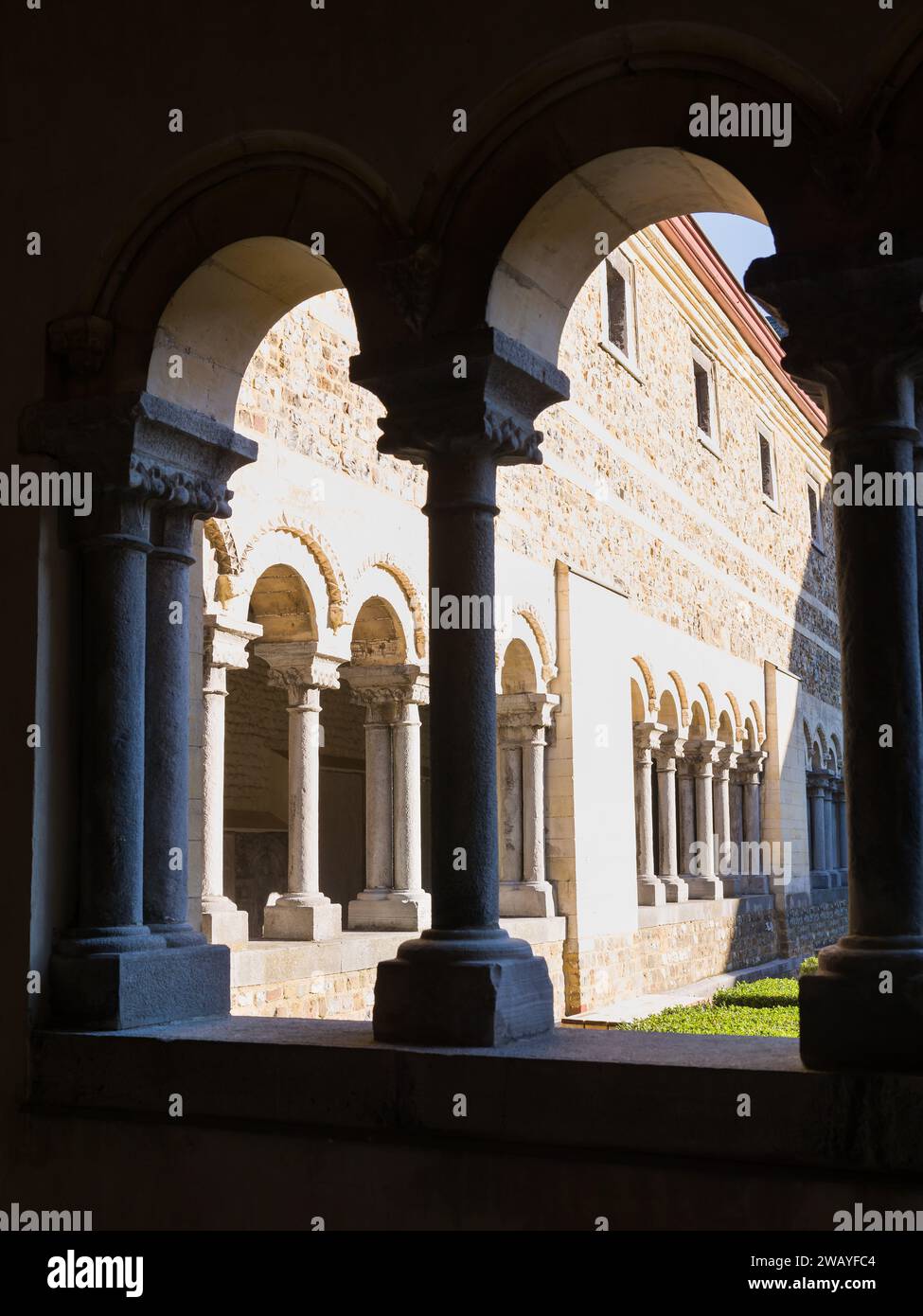 Pillars and arches of the medieval cloister courtyard of My Lady Cathedral in Tongeren in Belgium Stock Photo