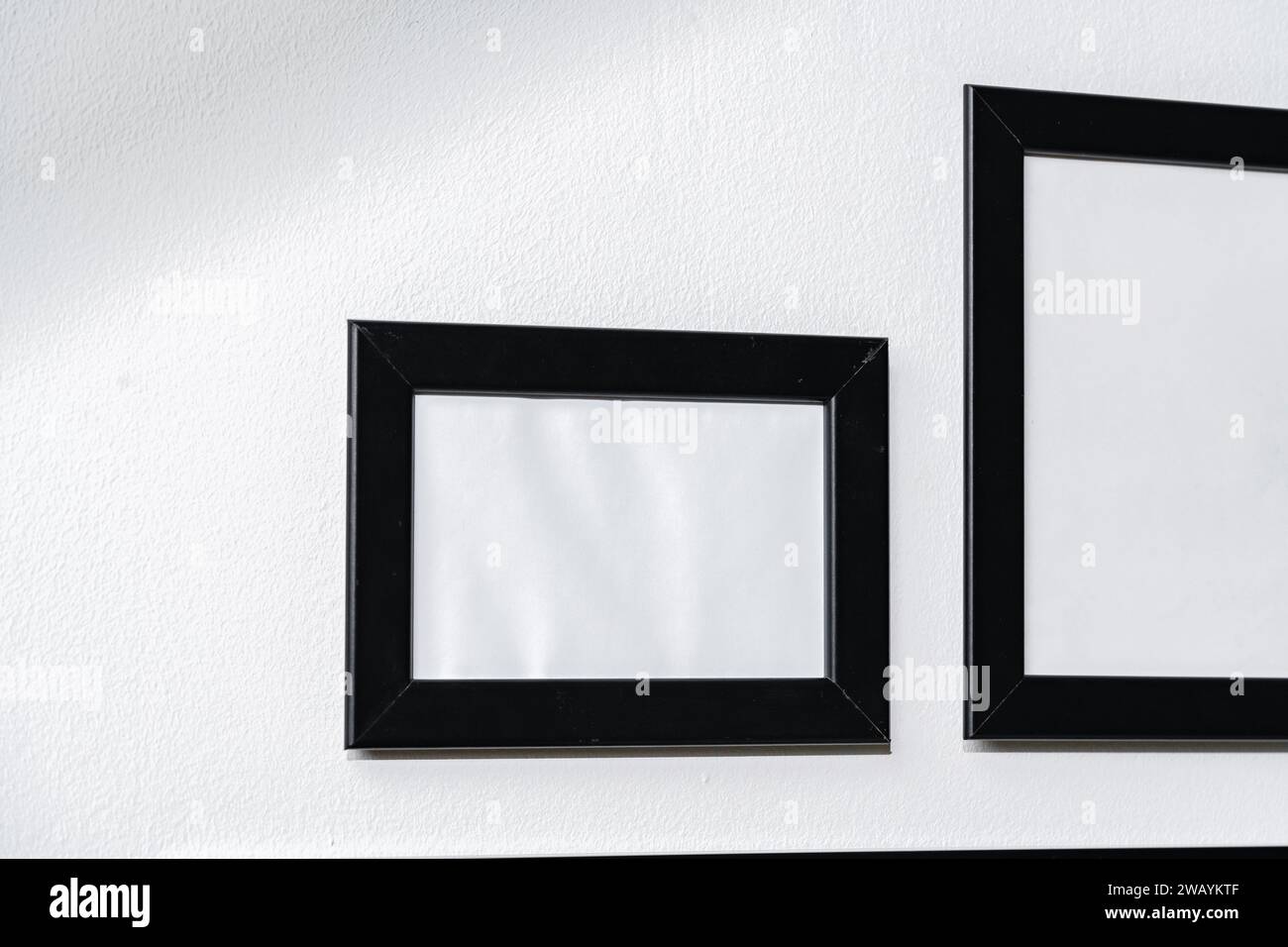 Set of black frames on white wall with copy space Stock Photo
