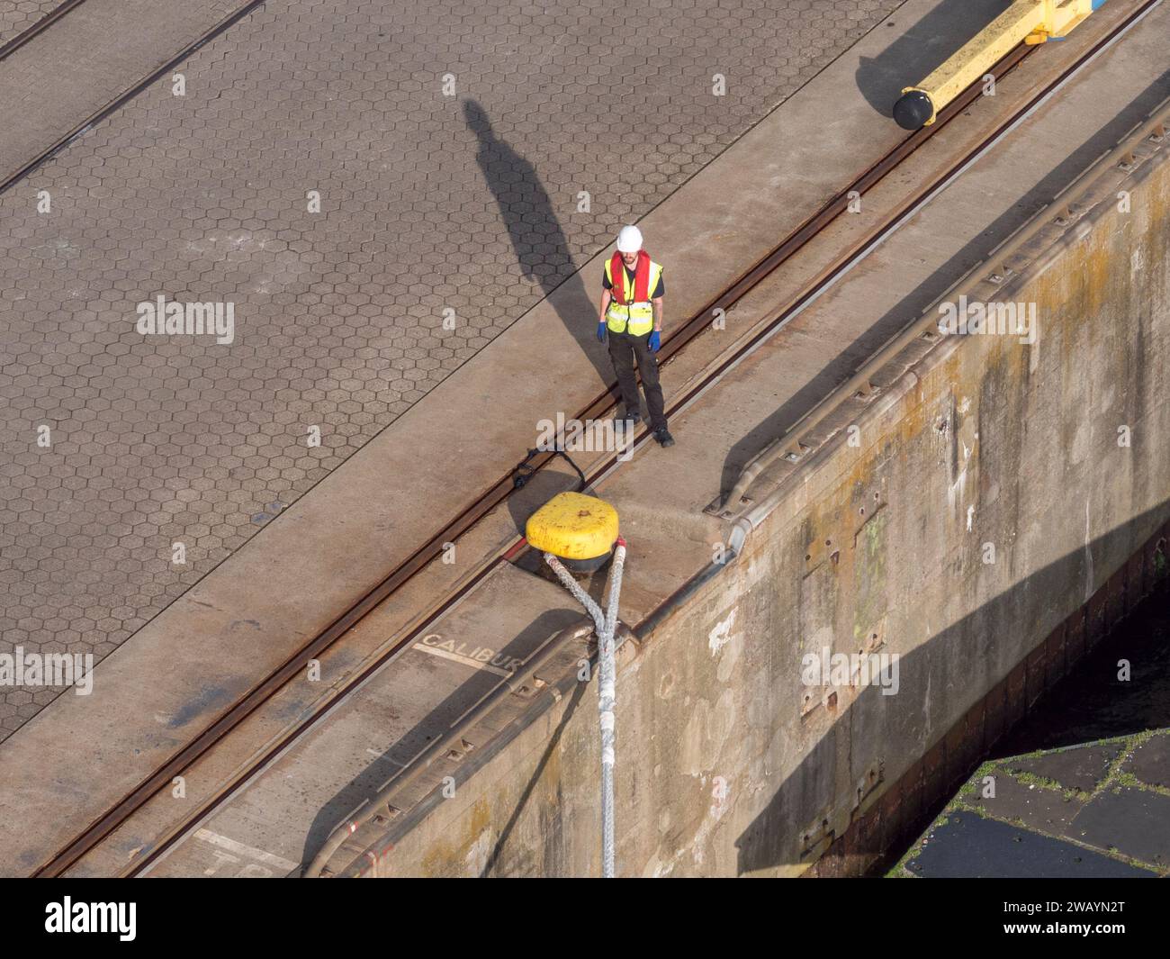 A dock worker waiting to remove the in the harbour in Kiel, Germany. Stock Photo