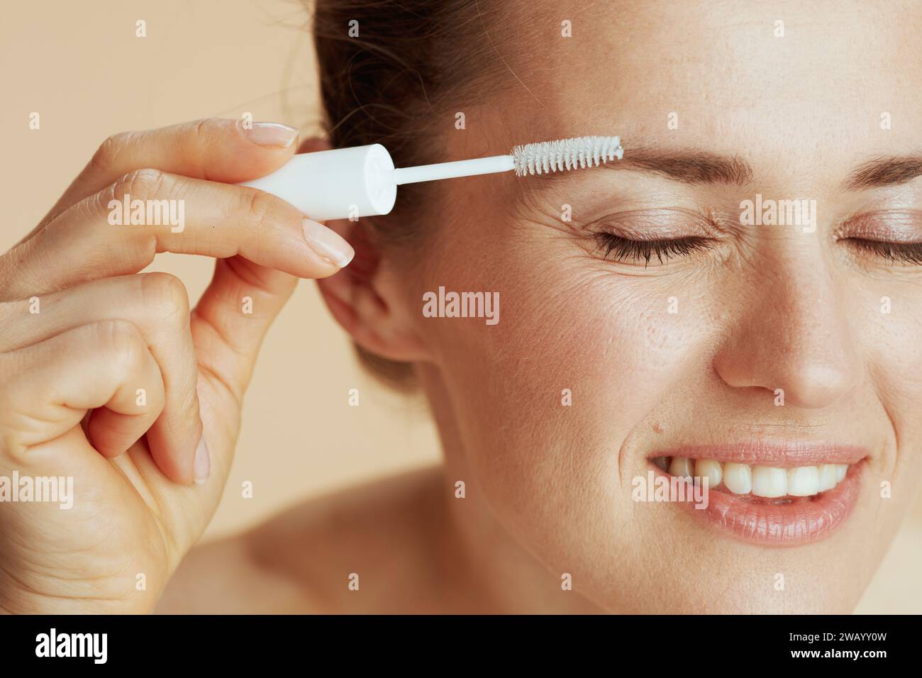 smiling modern female with brow brush. Stock Photo