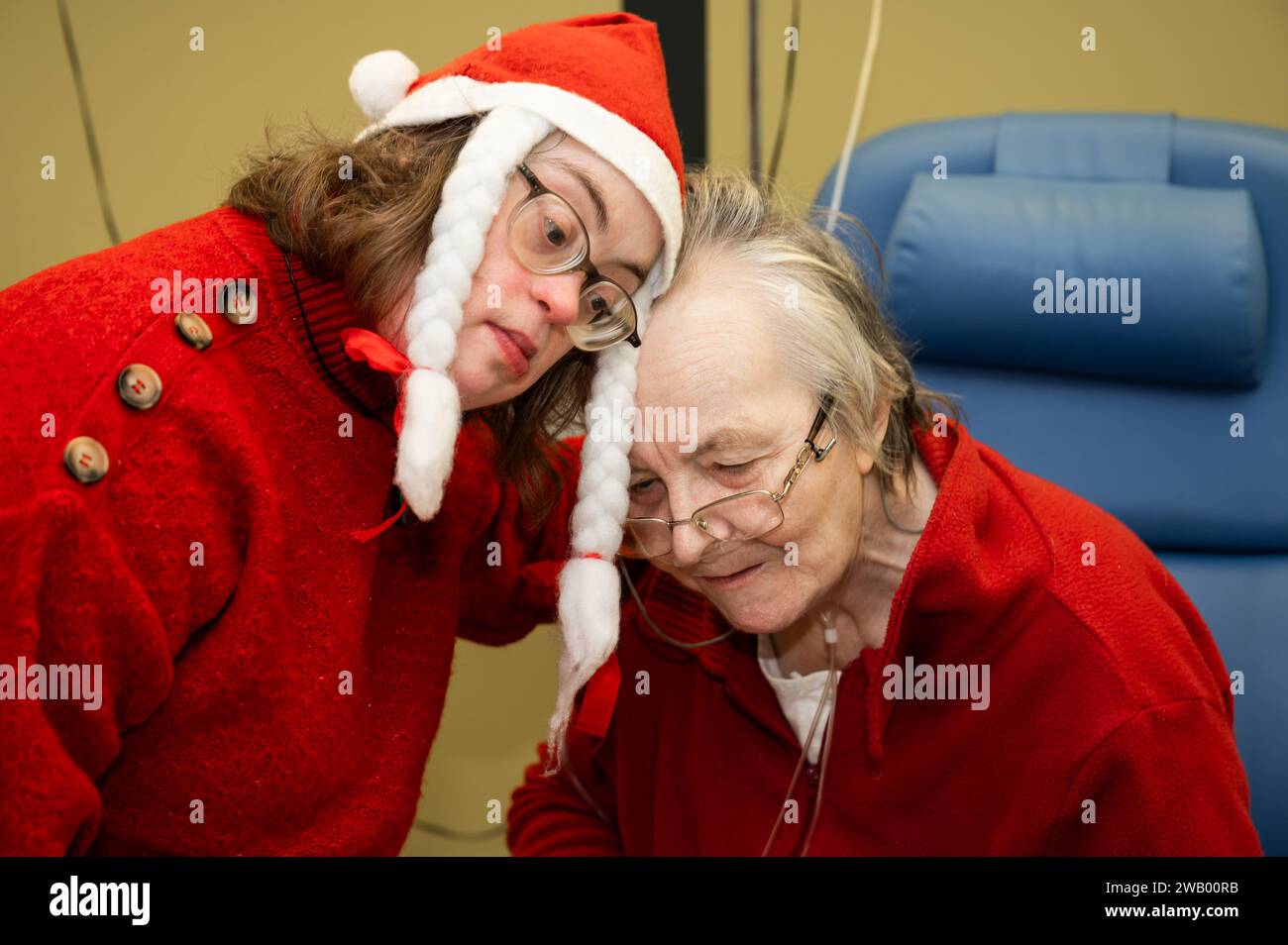 Tender family moment between a 41 yo woman with the Down Syndrome and her 85 yo mother during Christmas, Tienen, Belgium Stock Photo