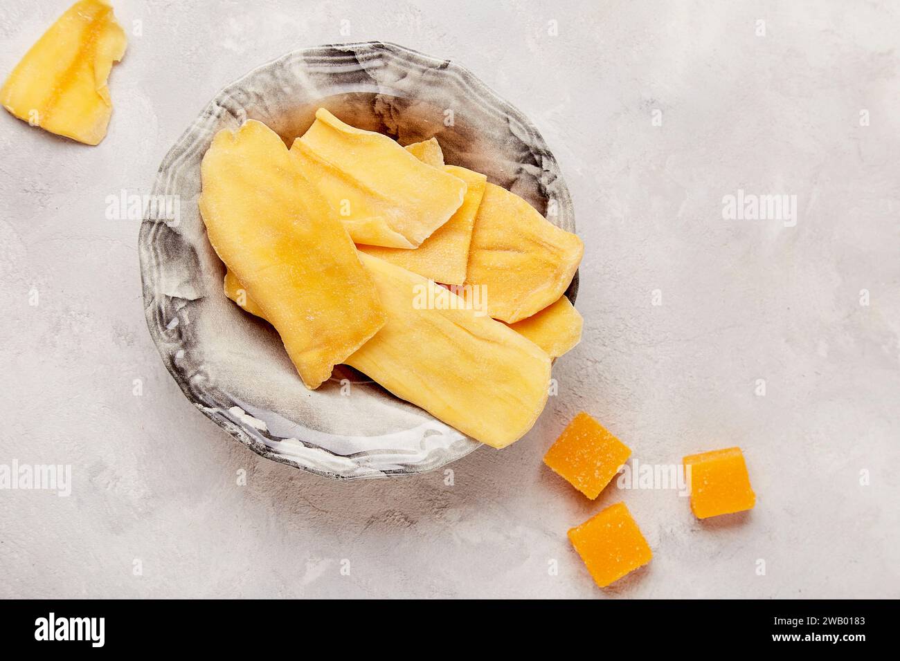 Tropical delight - vibrant shots of delectable dry mango slices top view. Stock Photo