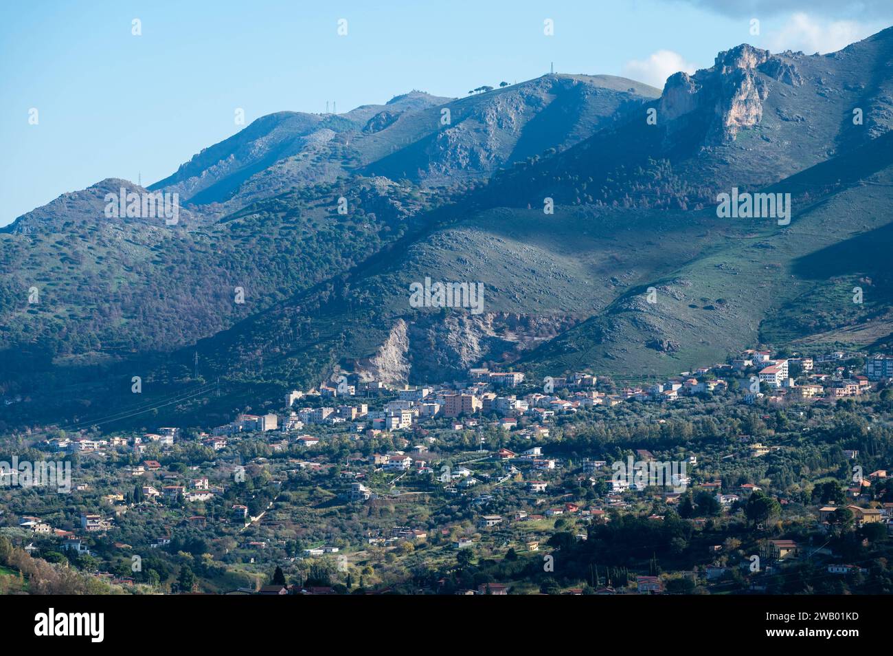 Panoramic view over the rough mountains with houses and blue sky around Cannizaro- Favare, Sicily, Italy Stock Photo