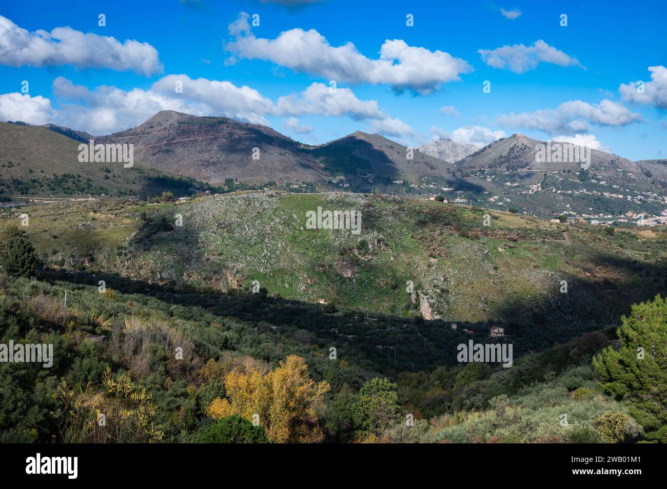 Panoramic view over the rough mountains with houses and blue sky around Cannizzaro - Favare, Sicily, Italy Stock Photo