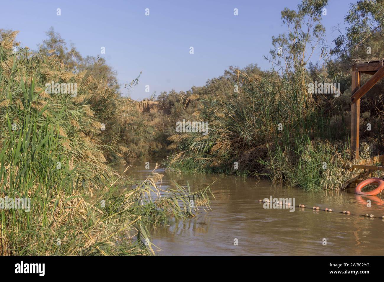 The Jordan river making a border between West Bank, Palestine, and Jordan at Qasr al-Yahud. Stock Photo