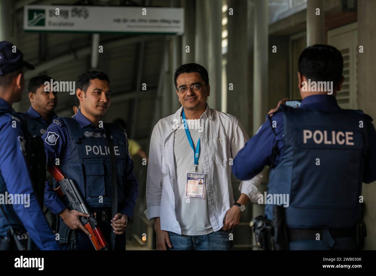 Khaled Muhiuddin, a Bangladeshi journalist of international news media Deutsche Welle (DW) takes photos with policemen. Stock Photo