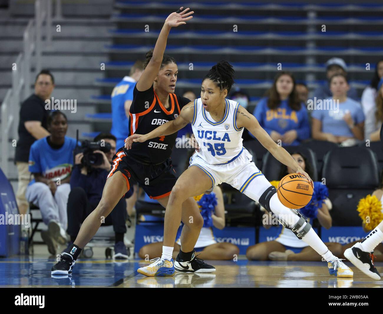 UCLA guard Camryn Brown, right, dribbles while defended by Oregon State