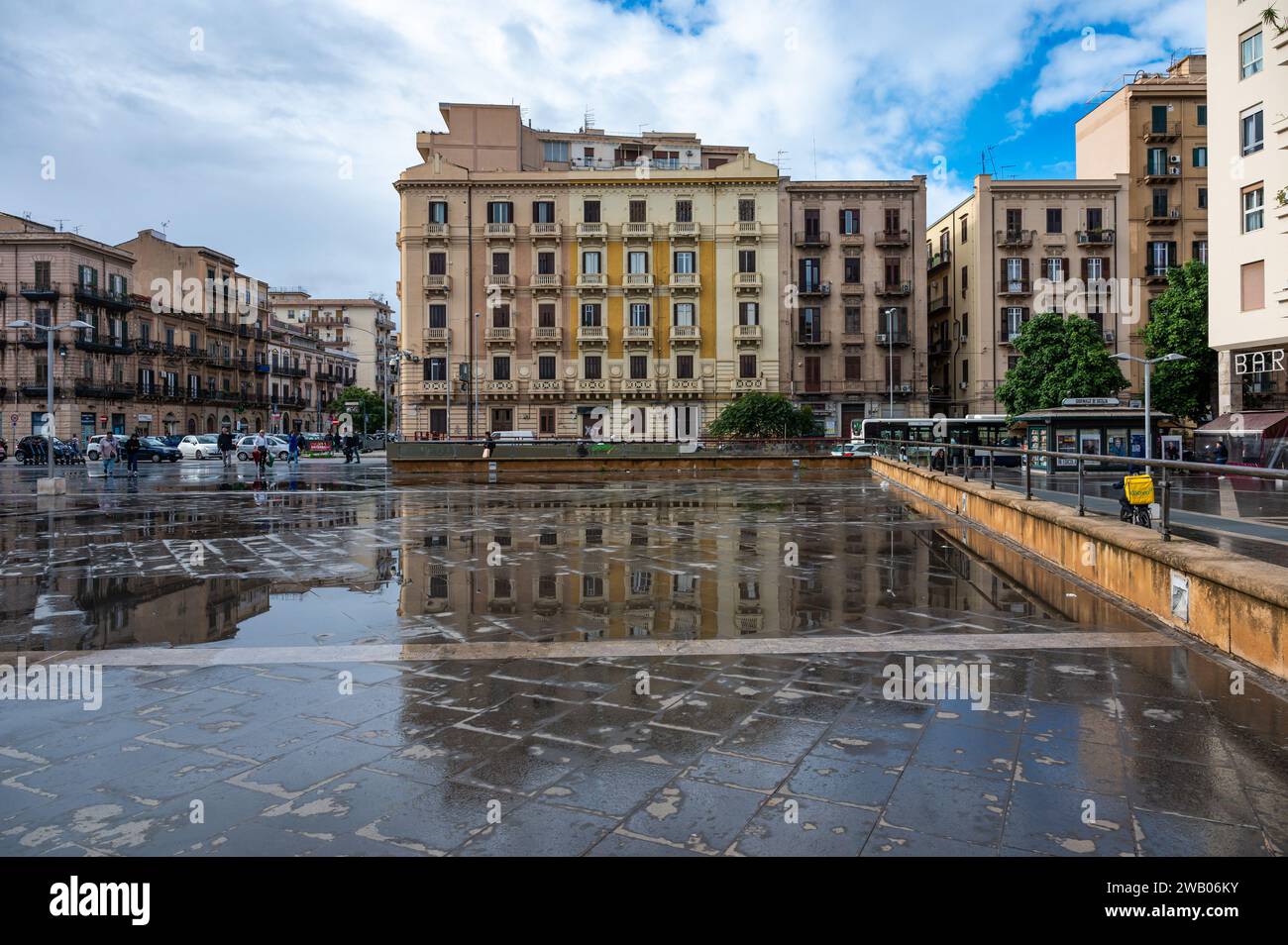 Palermo, Sicily, Italy, 15 December 2023 - The Vittorio Emanuele Orlando Square with restaurants and houses reflecting in the wet tiles Stock Photo