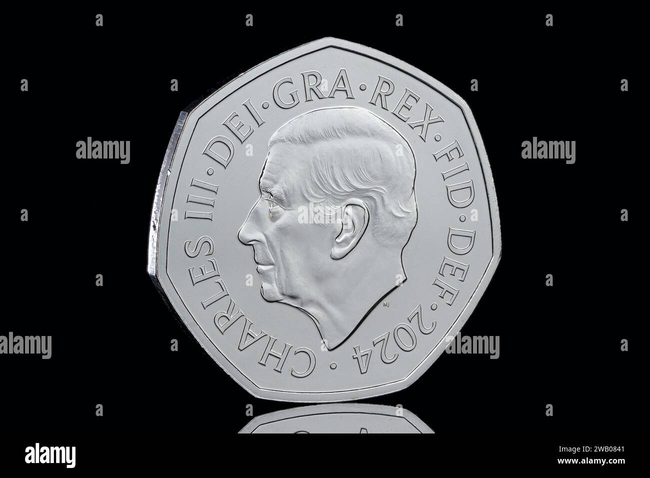 The Arctic Salmon 50 pence coin taken from the Definitive Annual Coin Set featuring the first coin portrait of King Charles III by Martin Jennings Stock Photo