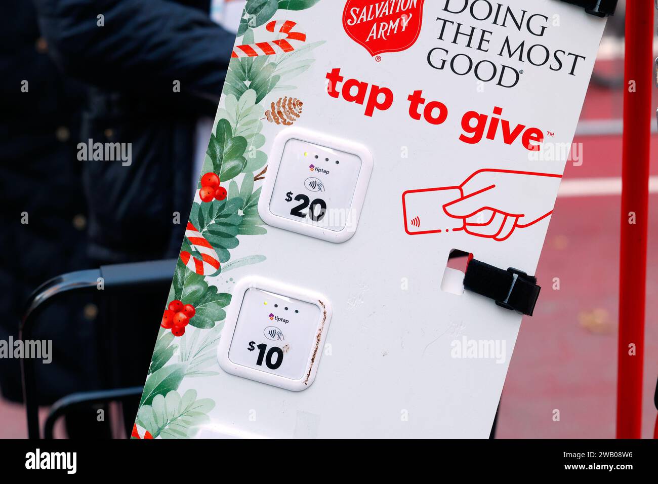 Tiptap touchless contactless payment credit card donation options at a Salvation Army Christmas Red Kettle fundraiser on a New York City sidewalk. Stock Photo