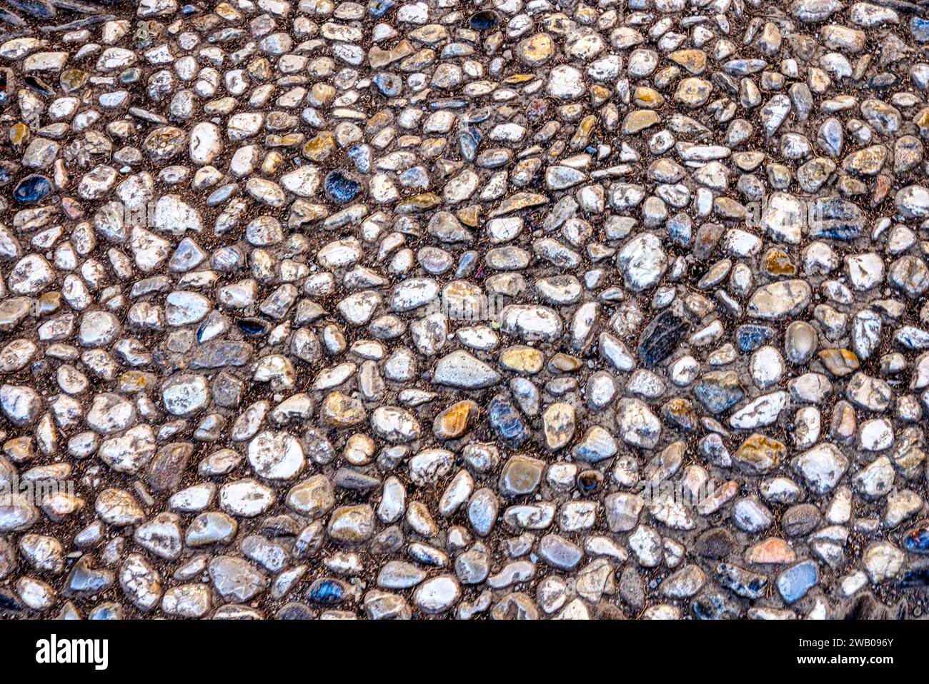 Weathered old cobble stone background of pebbles and stones Stock Photo