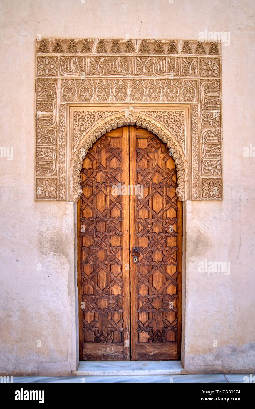 Old exterior wooden doorway with moorish arch doors Stock Photo