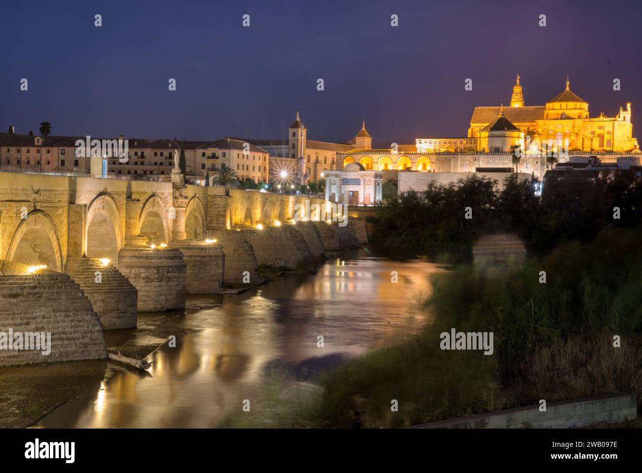 Ancient roman bridge over the Guadalquivir River in Cordoba Spain at night Stock Photo