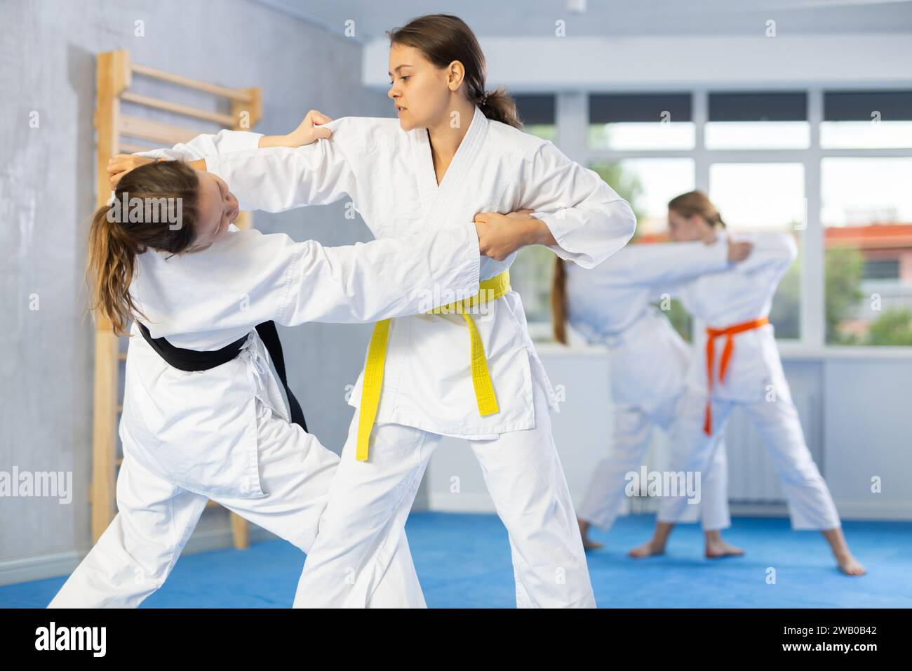 Pairs classes in judo or jiu jitsu two teenage girls practice