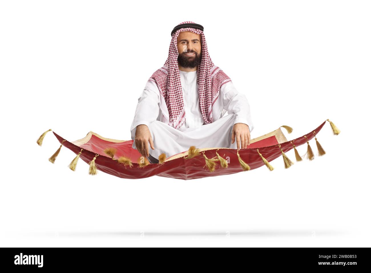 Bearded arab man sitting on a magic carpet and floating isolated on white background Stock Photo