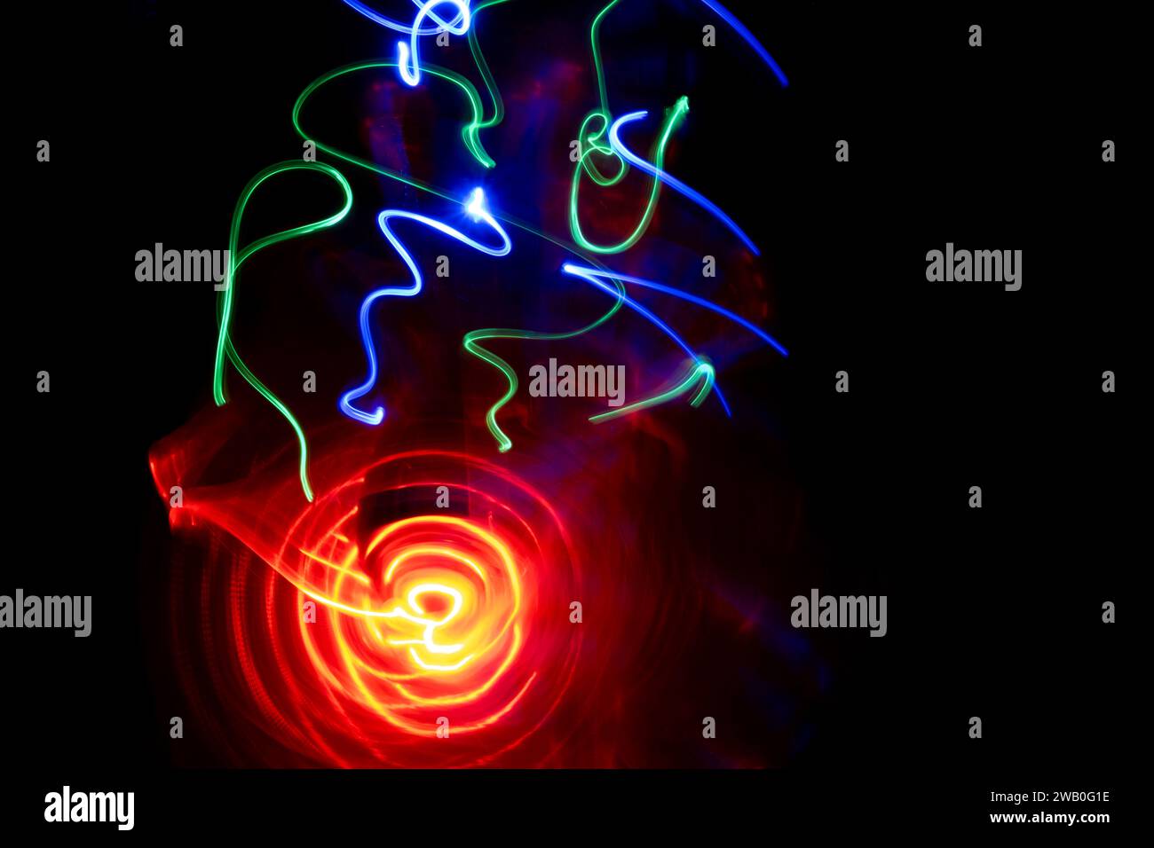 Bright lights on a black background - abstract motion in light painting. Stock Photo