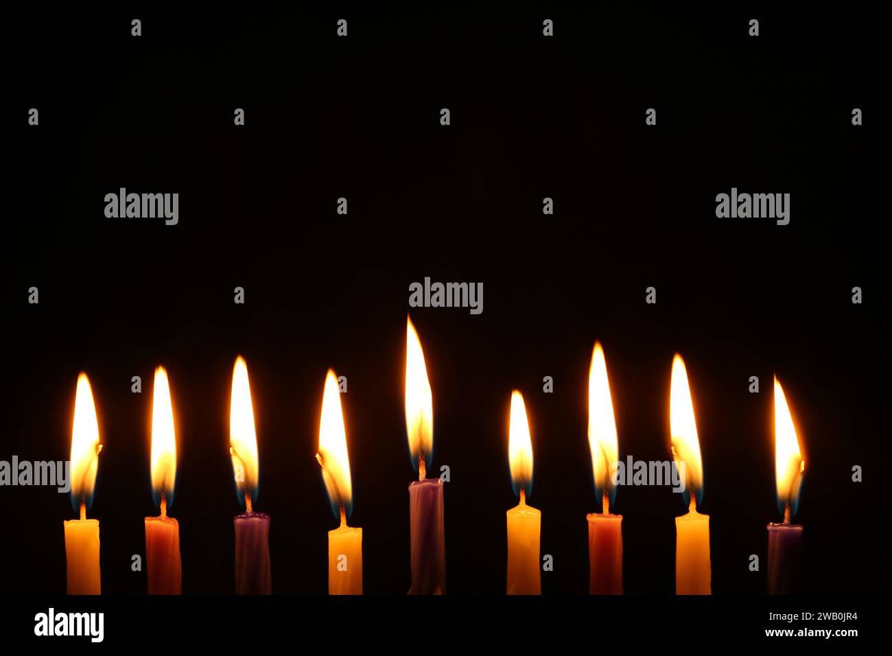 Hanukkah celebration. Burning candles on black background Stock Photo