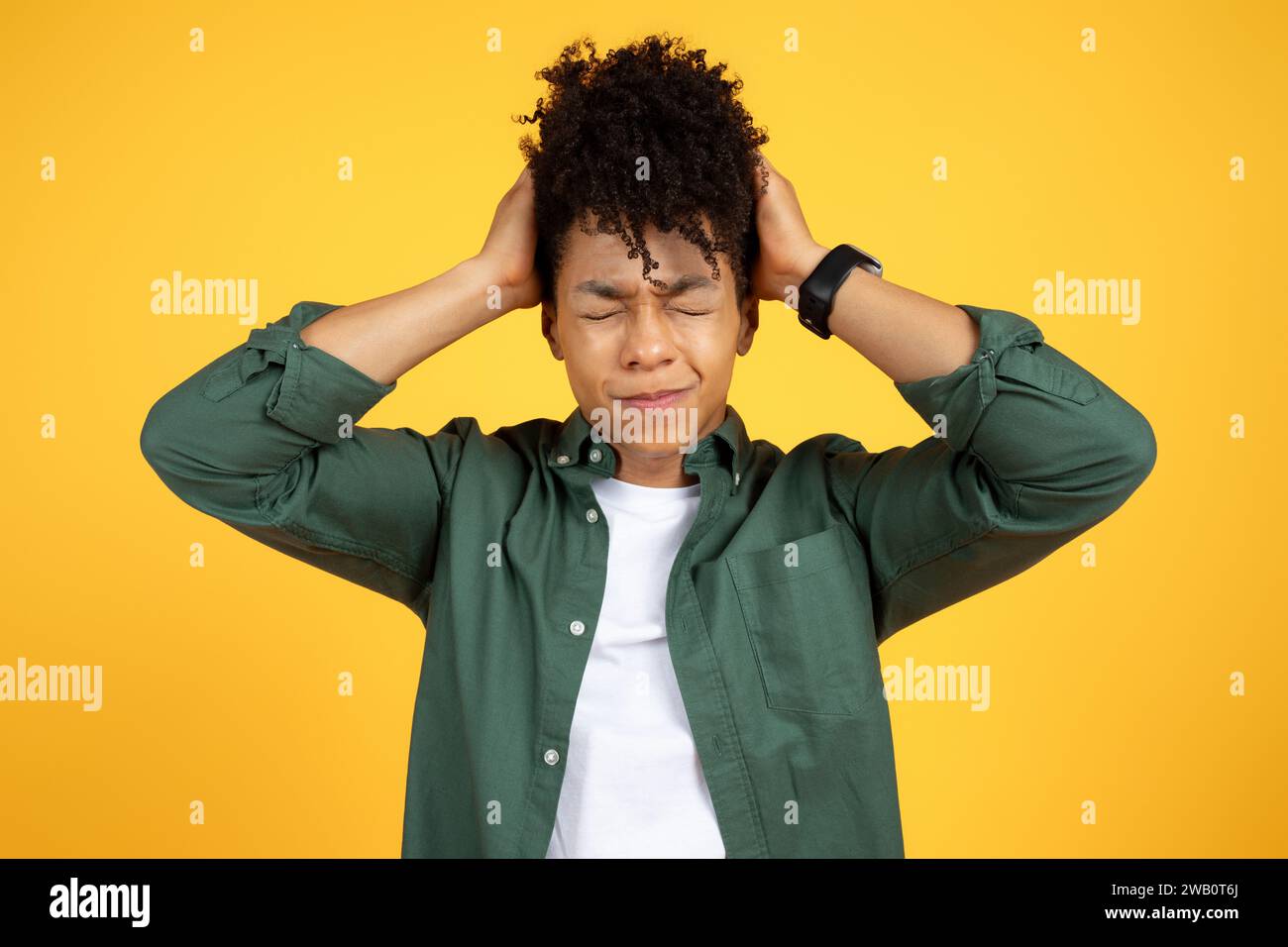Stressed young african american guy touching his head Stock Photo